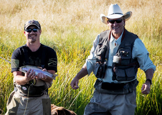 Happy veterans fishing in nature